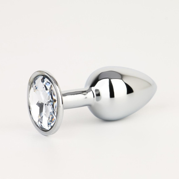 Серебристая анальная втулочка с прозрачным кристаллом - 7 см. Серебристая анальная втулочка с прозрачным кристаллом - 7 см.